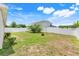 Spacious backyard with healthy green grass and a white fence, perfect for outdoor activities at 233 E Cattail, Lake Alfred, FL 33850