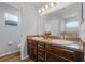 Bathroom features a double vanity, granite countertops, dark cabinetry, and tile flooring at 233 E Cattail, Lake Alfred, FL 33850