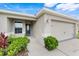 A charming home featuring a well-maintained lawn with vibrant landscaping near front entry at 233 E Cattail, Lake Alfred, FL 33850