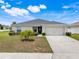Charming single-story home features a well-manicured lawn and attached two car garage at 233 E Cattail, Lake Alfred, FL 33850