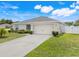 Charming single-story home features a well-manicured lawn and attached two car garage at 233 E Cattail, Lake Alfred, FL 33850