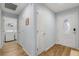 Hallway view featuring wood flooring, neutral paint, and access to laundry area at 233 E Cattail, Lake Alfred, FL 33850