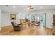Sun-filled living room showcases wood floors, chairs with blue pillows, and a view of the backyard at 233 E Cattail, Lake Alfred, FL 33850