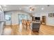 Spacious living room with wood flooring, furniture, entertainment center, and sliding glass doors at 233 E Cattail, Lake Alfred, FL 33850