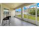 Screened patio overlooking spacious backyard, with large windows offering natural light and seamless outdoor living at 233 E Cattail, Lake Alfred, FL 33850