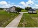 Sprawling estate featuring a two-story home, horse barn, private driveway, and fenced pastures with lush landscaping at 2350 Bradbury Rd, Haines City, FL 33844