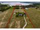 Aerial view of the property lines showcasing the main house, barn, and lake at 2350 Bradbury Rd, Haines City, FL 33844