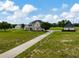 Expansive property featuring a two-story home, horse barn, fenced pastures, and a long private driveway at 2350 Bradbury Rd, Haines City, FL 33844