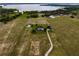 Aerial view of the property showcasing a main house, barn, and lake in the distance at 2350 Bradbury Rd, Haines City, FL 33844