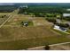 Expansive aerial view of the property featuring multiple buildings and sprawling green land at 2350 Bradbury Rd, Haines City, FL 33844