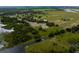 Expansive aerial view showing land with pond, dock, mature trees, and homes at 2350 Bradbury Rd, Haines City, FL 33844