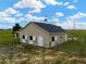 Charming barn featuring stalls with white doors and weathervane against a sunny blue sky at 2350 Bradbury Rd, Haines City, FL 33844