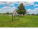 Charming barn exterior with a well-maintained green lawn and mature trees at 2350 Bradbury Rd, Haines City, FL 33844