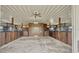 Well-maintained barn interior highlighting stalls with sturdy wooden doors, metal framework, concrete floor, and functional lighting at 2350 Bradbury Rd, Haines City, FL 33844