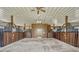 Clean barn featuring multiple horse stalls with wood and metal accents, with a concrete floor and overhead lighting at 2350 Bradbury Rd, Haines City, FL 33844