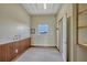Barn room with wainscoting, window, and access to another room and an exterior door at 2350 Bradbury Rd, Haines City, FL 33844