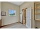 Inside barn with wainscoting, window, access to shower room with a full shower and glass door at 2350 Bradbury Rd, Haines City, FL 33844