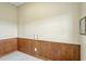 A utility room in a barn with wainscoting, blank wall, light switch, and a mirror at 2350 Bradbury Rd, Haines City, FL 33844
