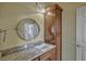 Bathroom vanity with granite countertop, mirror, and wooden cabinet at 2350 Bradbury Rd, Haines City, FL 33844