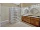 Modern bathroom featuring a glass block shower, double vanity sinks, and tasteful decorative mirrors and lighting at 2350 Bradbury Rd, Haines City, FL 33844