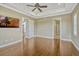 Expansive bedroom featuring hardwood floors, crown molding, and seamless access to other parts of the residence at 2350 Bradbury Rd, Haines City, FL 33844