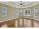 Spacious bedroom featuring a trey ceiling, crown molding, and multiple large windows overlooking the landscaped yard at 2350 Bradbury Rd, Haines City, FL 33844