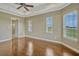 Light-filled bedroom with crown molding, tray ceiling, and hardwood floors, complemented by scenic outdoor views at 2350 Bradbury Rd, Haines City, FL 33844