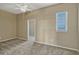 Bedroom featuring neutral carpet, ceiling fan and a doorway to the ensuite bathroom at 2350 Bradbury Rd, Haines City, FL 33844