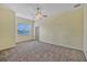 Spacious bedroom with a ceiling fan, large window, and neutral-toned walls at 2350 Bradbury Rd, Haines City, FL 33844