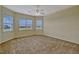 Bright primary bedroom with multiple windows and neutral carpet at 2350 Bradbury Rd, Haines City, FL 33844