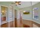 Bonus room with wood floors, shelving, and backyard views, leading to the bathroom at 2350 Bradbury Rd, Haines City, FL 33844