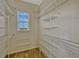 Walk-in closet featuring ample shelving and a small window at 2350 Bradbury Rd, Haines City, FL 33844