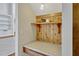 Close-up of a desk and shelving built into a hallway niche, with wood finishes at 2350 Bradbury Rd, Haines City, FL 33844