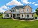 Stunning two-story home featuring stone accents, a manicured lawn and meticulous landscaping in a suburban neighborhood at 2350 Bradbury Rd, Haines City, FL 33844