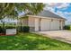 View of the three-car garage featuring an attached generator and stone accents at 2350 Bradbury Rd, Haines City, FL 33844