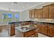 Kitchen with custom wood cabinets, granite countertops, and views of the backyard at 2350 Bradbury Rd, Haines City, FL 33844