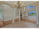 Spacious living area with hardwood floors, tall pillars, a stone fireplace, and sliding doors at 2350 Bradbury Rd, Haines City, FL 33844