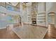 Open-concept living room with wood floors, stone fireplace, and custom built-ins at 2350 Bradbury Rd, Haines City, FL 33844