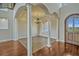 Bright, open-concept with tall pillars, and hardwood floors leading to the front entrance at 2350 Bradbury Rd, Haines City, FL 33844