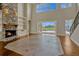 Sun-filled living room features a stone fireplace, and views of the outdoor pool at 2350 Bradbury Rd, Haines City, FL 33844