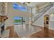Bright living room boasts soaring ceilings, wood floors, and grand stone fireplace at 2350 Bradbury Rd, Haines City, FL 33844