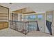 Bright loft space overlooking the main living area and featuring a stone fireplace and decorative wrought iron railing at 2350 Bradbury Rd, Haines City, FL 33844