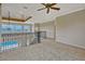 Spacious loft area features plush carpeting, decorative railings, and views of the pool below at 2350 Bradbury Rd, Haines City, FL 33844
