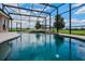 Sparkling pool within screened enclosure, offering views of the expansive backyard at 2350 Bradbury Rd, Haines City, FL 33844
