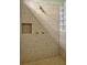 Walk-in shower featuring stone tile, with shower niche and glass block adding natural light at 2350 Bradbury Rd, Haines City, FL 33844