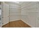 Spacious walk-in closet with installed shelving and hardwood flooring, perfect for organized storage solutions at 2350 Bradbury Rd, Haines City, FL 33844