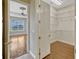 Walk-in closet featuring an open door and hardwood flooring; bedroom with large windows is visible through the entry at 2350 Bradbury Rd, Haines City, FL 33844