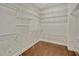 Large walk-in closet with installed shelving and hardwood flooring, ideal for storing clothes and accessories at 2350 Bradbury Rd, Haines City, FL 33844