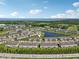 Aerial view of new townhome community with a scenic pond and nearby lake and golf course at 2462 Sweet Viburnum Way, Ocoee, FL 34761
