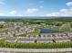 Aerial view of community with lake and golf course; beautiful landscaping and sunny skies at 2462 Sweet Viburnum Way, Ocoee, FL 34761
